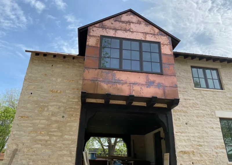 Copper metal panel facade on a stone building for Skylight Installation in Collinsville