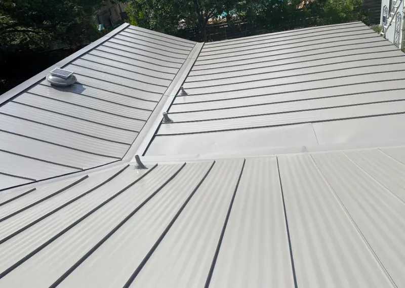 Solar attic fan installed on a metal roof for Roof Ventilation in Collinsville